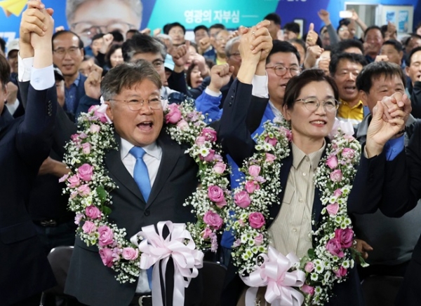 10ㆍ16 재ㆍ보궐선거가 실시된 16일 오후 전남 영광군수 재선거에서 당선이 확실시된 더불어민주당 장세일 후보가 배우자 정수미 씨와 화환을 목에 걸고 지지자들에게 인사하고 있다. (사진=연합뉴스)